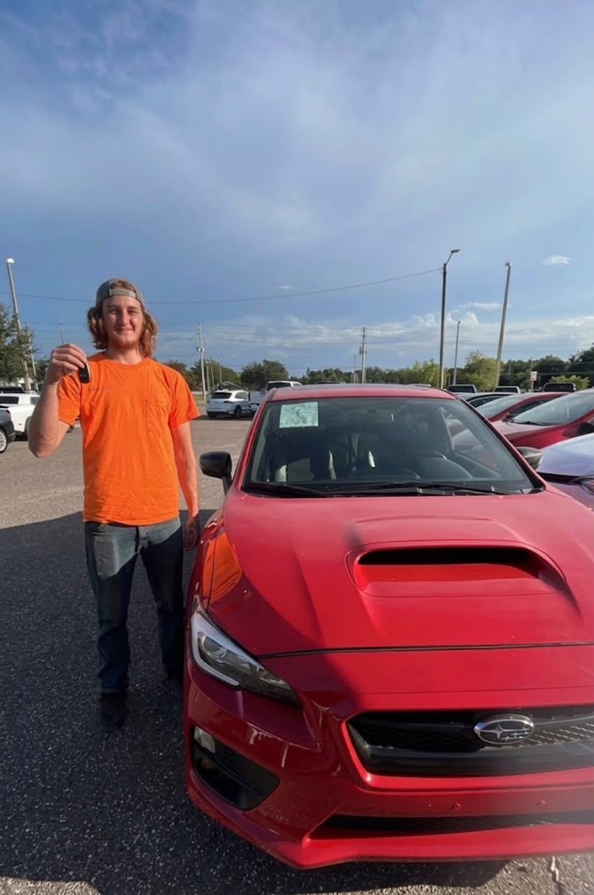 Customer holding up keys to his new Subaru WRX