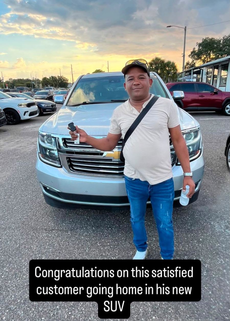 Customer holding up keys to his new SUV